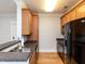 This kitchen features stainless steel sink, granite countertops and hardwood cabinets and floors at 412 Waterford Lake Dr, Cary, NC 27519