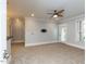 Carpeted living room features a ceiling fan, recessed lighting, and access to a private outdoor space at 412 Waterford Lake Dr, Cary, NC 27519