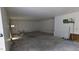 Unfinished basement with concrete floors, white walls, and a utility door; offering potential for customization at 42 Miry Branch Ct, Garner, NC 27529