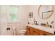 Modern bathroom with a dual sink vanity, wood cabinets, and updated fixtures at 42 Miry Branch Ct, Garner, NC 27529