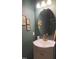 Powder room features an oval mirror, decorative fixtures and neutral colors at 42 Miry Branch Ct, Garner, NC 27529