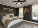 Well-lit bedroom with neutral tones, dark accent wall, decorative accents, and comfortable furnishings for a serene retreat at 42 Miry Branch Ct, Garner, NC 27529
