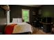 Bedroom with gray walls, wood flooring, and desk setup at 42 Miry Branch Ct, Garner, NC 27529