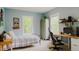 Light-filled bedroom featuring two windows, dark walls, and desk space at 42 Miry Branch Ct, Garner, NC 27529