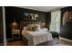 Sophisticated bedroom with dark accent wall, plush bedding, and decorative lighting creating a relaxing ambiance at 42 Miry Branch Ct, Garner, NC 27529