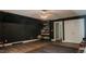Large bonus room featuring custom built-in bookcase and hardwood flooring at 42 Miry Branch Ct, Garner, NC 27529