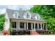 Stately two-story home with a covered front porch, classic columns, and landscaped front yard with brick steps at 42 Miry Branch Ct, Garner, NC 27529