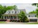 Charming two-story home boasts a classic white exterior, attached two-car garage and a welcoming covered front porch at 42 Miry Branch Ct, Garner, NC 27529