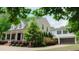 Two-story home boasts a covered front porch, dormer windows, attached garage and landscaped front yard at 42 Miry Branch Ct, Garner, NC 27529