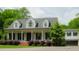 Charming home with a covered front porch, dormer windows, and mature landscaping, creating curb appeal at 42 Miry Branch Ct, Garner, NC 27529