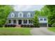 Inviting two-story home featuring a classic white facade, dark shutters, and a well-maintained lawn at 42 Miry Branch Ct, Garner, NC 27529