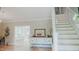 Bright foyer with hardwood floors, staircase, and decorative console table offers a warm welcome at 42 Miry Branch Ct, Garner, NC 27529