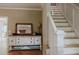 Bright foyer boasts hardwood floors, staircase, and elegant console table with mirror and light fixture at 42 Miry Branch Ct, Garner, NC 27529