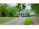 A long driveway leads to this charming white house with three dormers, a wide porch, and an attached two-car garage at 42 Miry Branch Ct, Garner, NC 27529
