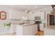 Well-equipped kitchen with white cabinets, a central island, and stainless steel appliances at 42 Miry Branch Ct, Garner, NC 27529