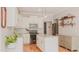 Modern kitchen with white cabinets, stainless steel appliances, an island, and decor shelves at 42 Miry Branch Ct, Garner, NC 27529
