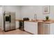 Modern kitchen boasting stainless steel appliances, light wood countertops, and white cabinets at 42 Miry Branch Ct, Garner, NC 27529