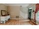 Sunlit living room features hardwood floors, a staircase, front door, and a vintage-style dresser at 42 Miry Branch Ct, Garner, NC 27529