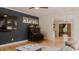 Stylish living room with modern decor, featuring a navy accent wall and hardwood flooring throughout the room at 42 Miry Branch Ct, Garner, NC 27529