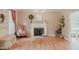 Bright living room featuring hardwood floors, a fireplace, and tasteful decorations for a cozy ambiance at 42 Miry Branch Ct, Garner, NC 27529