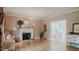 Elegant living room features a fireplace, hardwood floors, and abundant natural light with adjacent dining area at 42 Miry Branch Ct, Garner, NC 27529