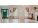 Bright living room with wallpaper, hardwood floors, fireplace, and large windows offers a cozy atmosphere at 42 Miry Branch Ct, Garner, NC 27529