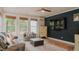 Well-lit sun room featuring comfortable seating and scenic views from the many windows at 42 Miry Branch Ct, Garner, NC 27529