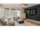 Bright sunroom with large windows, cozy seating, and neutral color scheme, ideal for relaxing and entertaining guests at 42 Miry Branch Ct, Garner, NC 27529