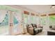 Bright sunroom featuring french doors and large windows, offering ample natural light and views of the surrounding greenery at 42 Miry Branch Ct, Garner, NC 27529