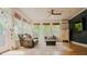 Cozy sunroom with a seating arrangement, many windows, and hardwood floors, creating a warm and inviting atmosphere at 42 Miry Branch Ct, Garner, NC 27529