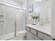 Bathroom featuring a glass shower, grey vanity and matching framed mirror at 425 Shadow Falls Dr, Wendell, NC 27591