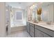 Stylish bathroom with double vanities, white cabinets, and a separate tub and shower at 425 Shadow Falls Dr, Wendell, NC 27591