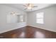 Bright bedroom features ceiling fan, hardwood floors and mirror at 425 Shadow Falls Dr, Wendell, NC 27591