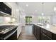A gourmet kitchen boasting modern appliances, quartz countertops, and open layout to the screened porch at 425 Shadow Falls Dr, Wendell, NC 27591