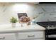 Close-up of kitchen counter with stainless steel appliances with stylish cookbook and decorative accents at 425 Shadow Falls Dr, Wendell, NC 27591