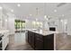 Modern open kitchen with stainless steel appliances, a stylish island and an adjacent living space at 425 Shadow Falls Dr, Wendell, NC 27591