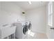 This bright laundry room has a washing machine and sink at 425 Shadow Falls Dr, Wendell, NC 27591