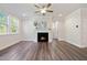 Bright living room featuring a fireplace, wood floors, and large windows that bring in lots of light at 425 Shadow Falls Dr, Wendell, NC 27591