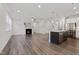 Open-concept living room flows into the kitchen, featuring a fireplace and plenty of natural light at 425 Shadow Falls Dr, Wendell, NC 27591