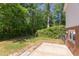 Lush backyard with mature trees, green lawn, and a concrete patio at 4300 Edgehill Ct, Raleigh, NC 27612