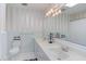 Bright bathroom with a double sink vanity, tiled walls, and a large mirror at 4300 Edgehill Ct, Raleigh, NC 27612