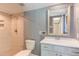 Bathroom with tiled walk-in shower, vanity, and framed mirror offers a clean and functional space at 4300 Edgehill Ct, Raleigh, NC 27612