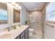 Modern bathroom featuring double vanity and walk-in shower with glass door and tile surround at 4300 Edgehill Ct, Raleigh, NC 27612