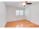 Bedroom with ceiling fan and hardwood floors and closet with a window providing natural light at 4300 Edgehill Ct, Raleigh, NC 27612