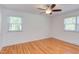 Bedroom with ceiling fan and hardwood floors with sunlit windows providing an outdoor view at 4300 Edgehill Ct, Raleigh, NC 27612