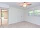 Bedroom features carpet, a ceiling fan, a window, and a closet, offering a bright living space at 4300 Edgehill Ct, Raleigh, NC 27612