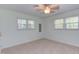 Bright bedroom with a ceiling fan, carpet, and ample natural light from large windows at 4300 Edgehill Ct, Raleigh, NC 27612