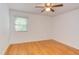 Bedroom featuring hardwood floors, a ceiling fan, and a window with natural light at 4300 Edgehill Ct, Raleigh, NC 27612