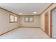 Carpeted bedroom with two windows, wood trim, and recessed lights provides comfort and ample natural light at 4300 Edgehill Ct, Raleigh, NC 27612