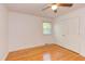 Cozy bedroom features hardwood floors, ceiling fan, closet, and natural lighting at 4300 Edgehill Ct, Raleigh, NC 27612